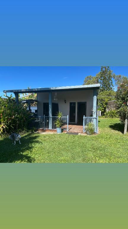 a house with a cat standing in front of it at Waterview Cottage in Baffle Creek