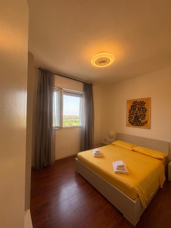 a bedroom with a bed and a window at Vivi IL RIFUGIO NEL CIELO in Bologna