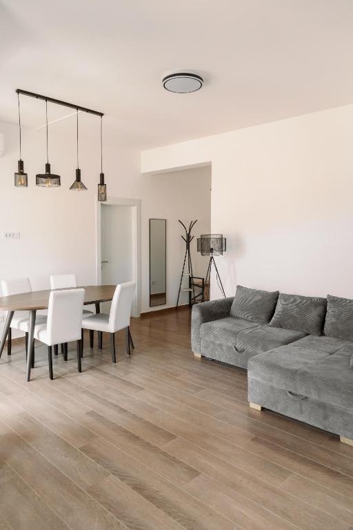 a living room with a table and a couch at Big Family apartment - 3BR in Budva