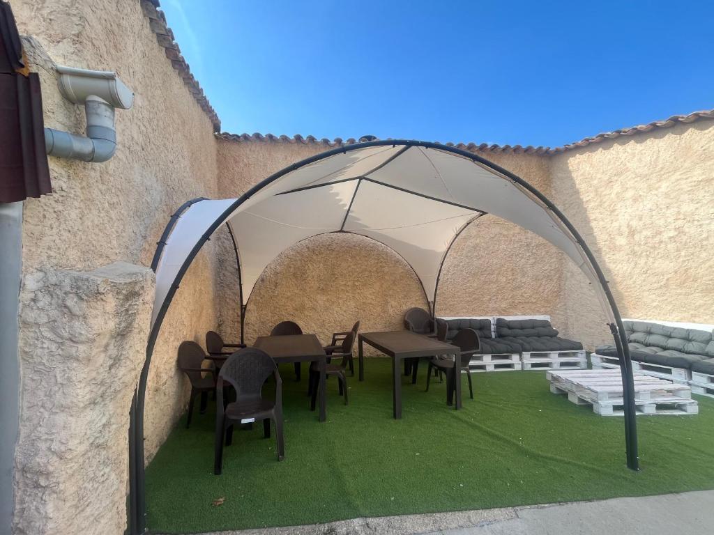 a gazebo with tables and chairs in a patio at Casa Rural Boni in Fuentemolinos