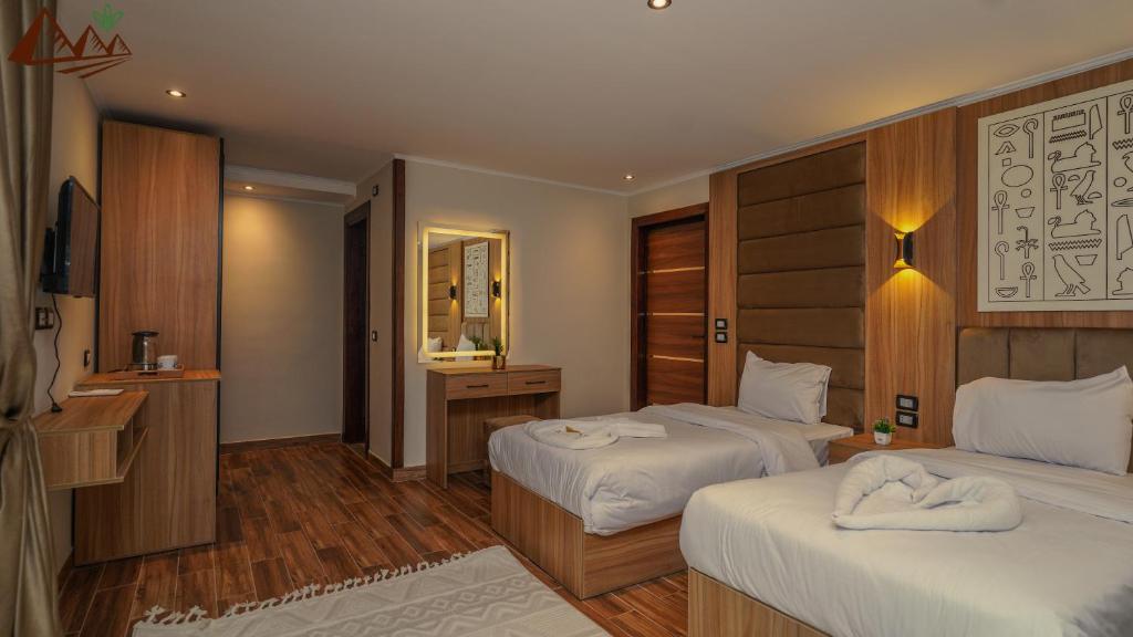 Postel nebo postele na pokoji v ubytování Suzana Pyramids hotel