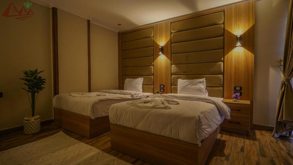 Postel nebo postele na pokoji v ubytování Suzana Pyramids hotel