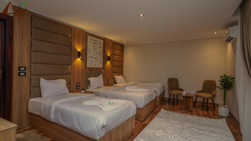 Postel nebo postele na pokoji v ubytování Suzana Pyramids hotel