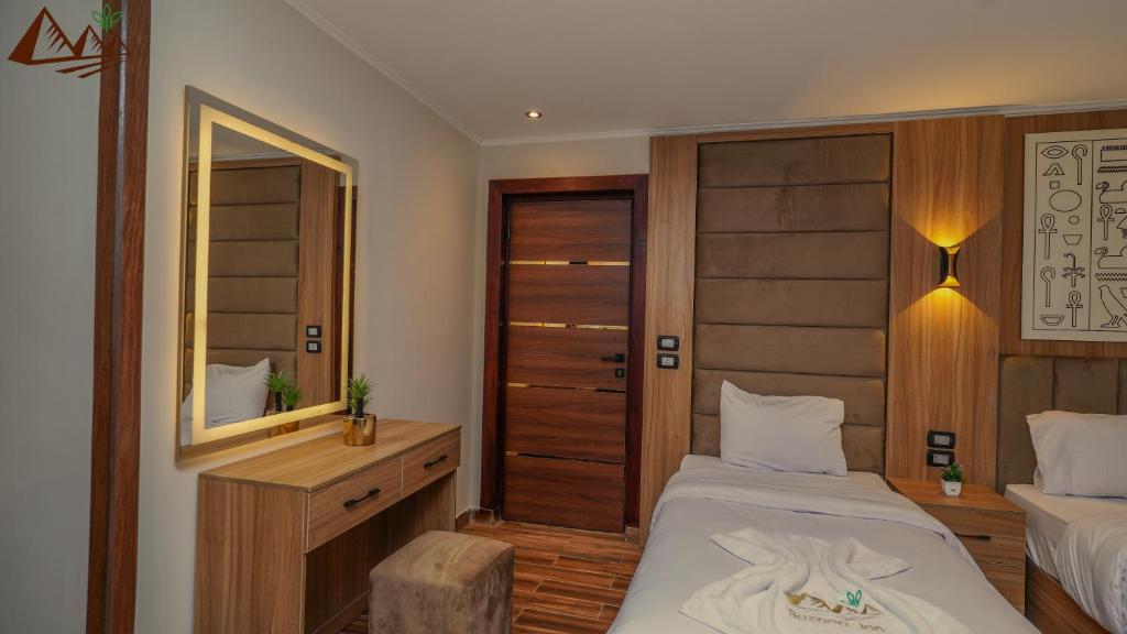 Postel nebo postele na pokoji v ubytování Suzana Pyramids hotel