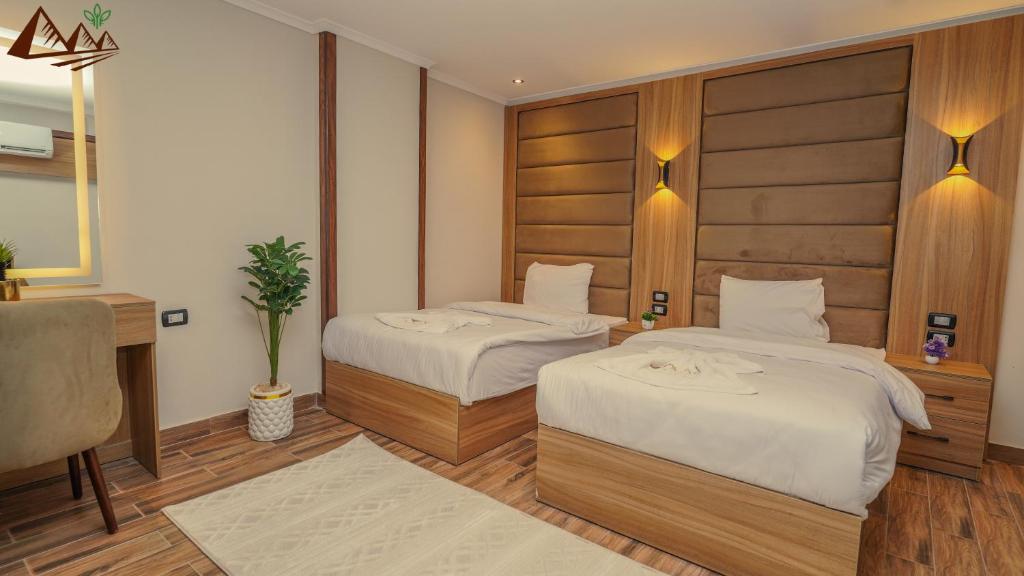 Postel nebo postele na pokoji v ubytování Suzana Pyramids hotel