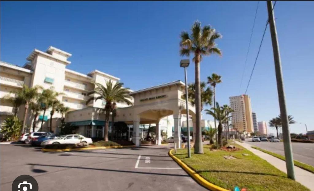 un grande edificio con palme e un parcheggio di Grand Seas Resort a Daytona Beach