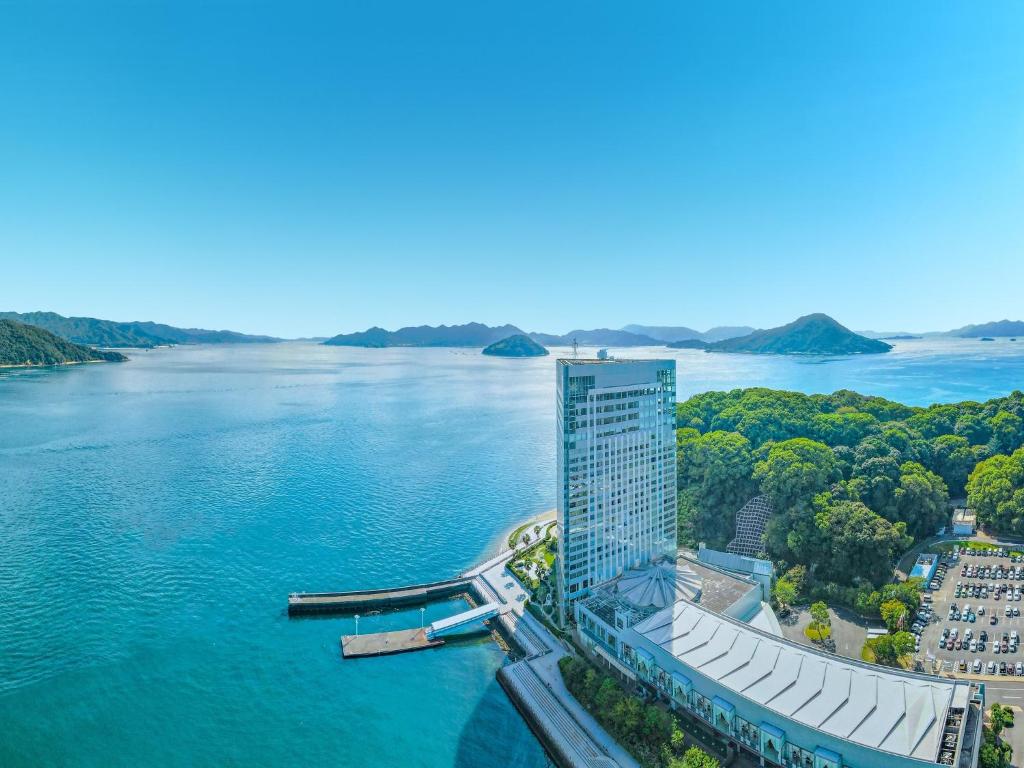 an aerial view of a building next to a body of water at Grand Prince Hotel Hiroshima in Hiroshima