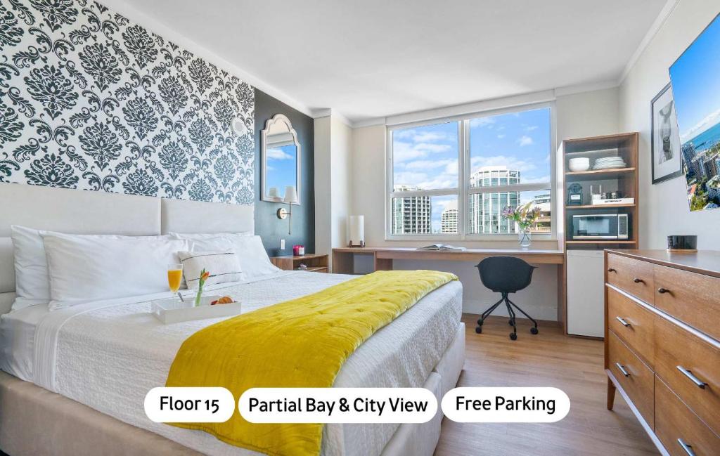 a bedroom with a large bed and a desk with a desk at MVR Relax in Suite with Biscayne Bay Sunsets in Miami