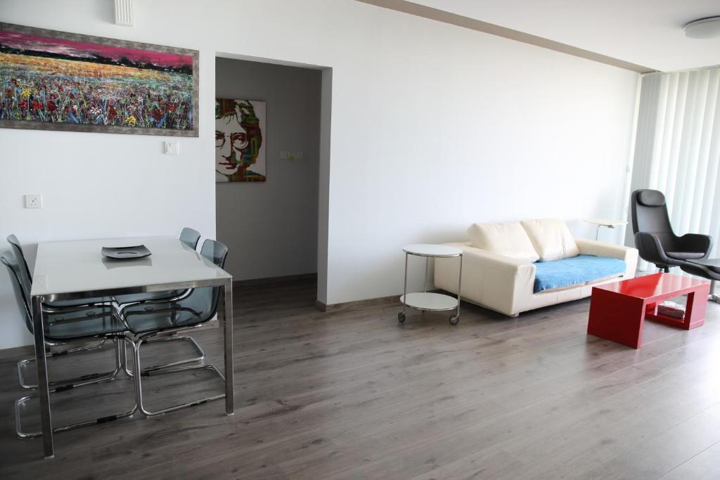 a living room with a couch and a table at Salt Lake view Apartment in Larnaca
