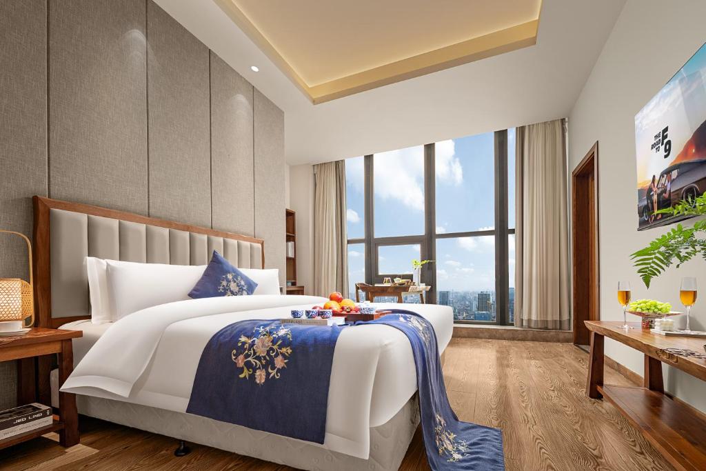 Postel nebo postele na pokoji v ubytování Yuanshe Yiju Hotel