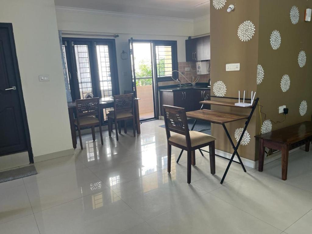 a kitchen and dining room with a table and chairs at 2 Bedroom Family apartment in cooke town in Bengaluru