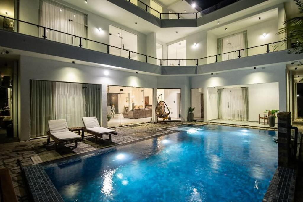 a large swimming pool with blue water in a house at Villa Mossa Ambalangoda Boutique villa villa in Ambalangoda