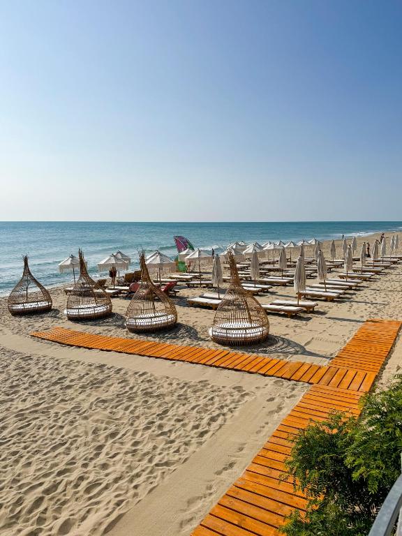 a row of chairs and chairs on a beach at La Boheme - Adults Only in Obzor