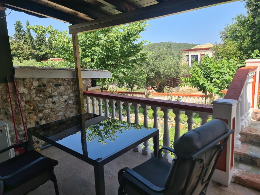 a balcony with a table and chairs and a view at Edem Studios in Syvota