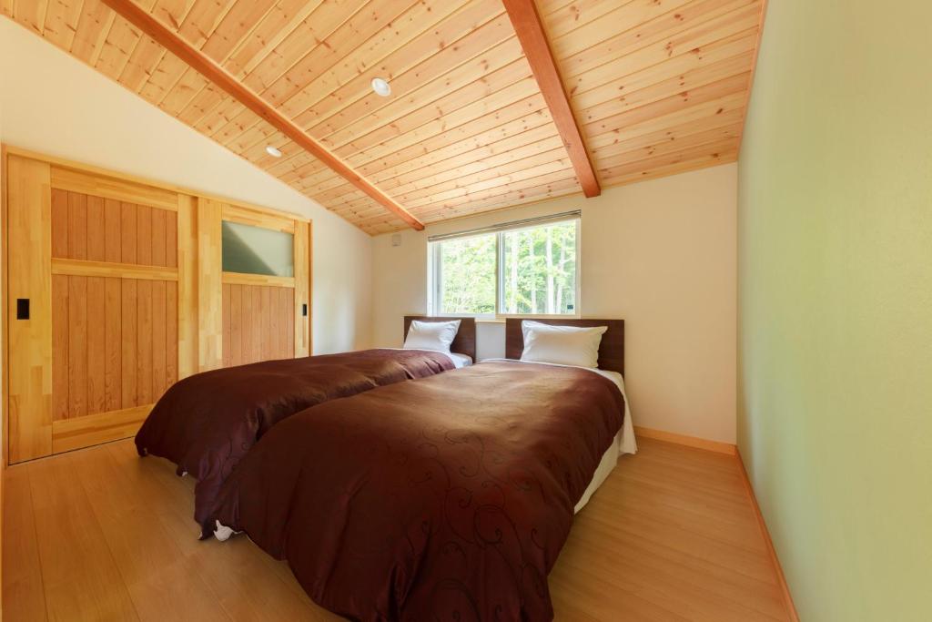 Postel nebo postele na pokoji v ubytování Izumigo AMBIENT Azumino Cottage