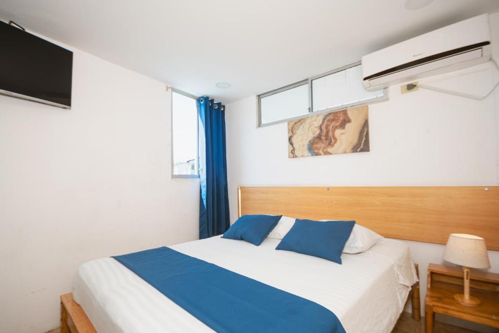 Postel nebo postele na pokoji v ubytování Hotel Casa Latina