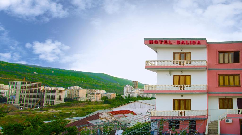 a building with a sign on it in a city at Hotel Dalida in Tbilisi City