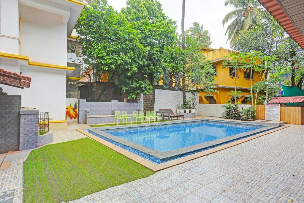a swimming pool in the backyard of a house at FabHotel 22 Squares Living Spaces - Nr Calangute Beach in Calangute