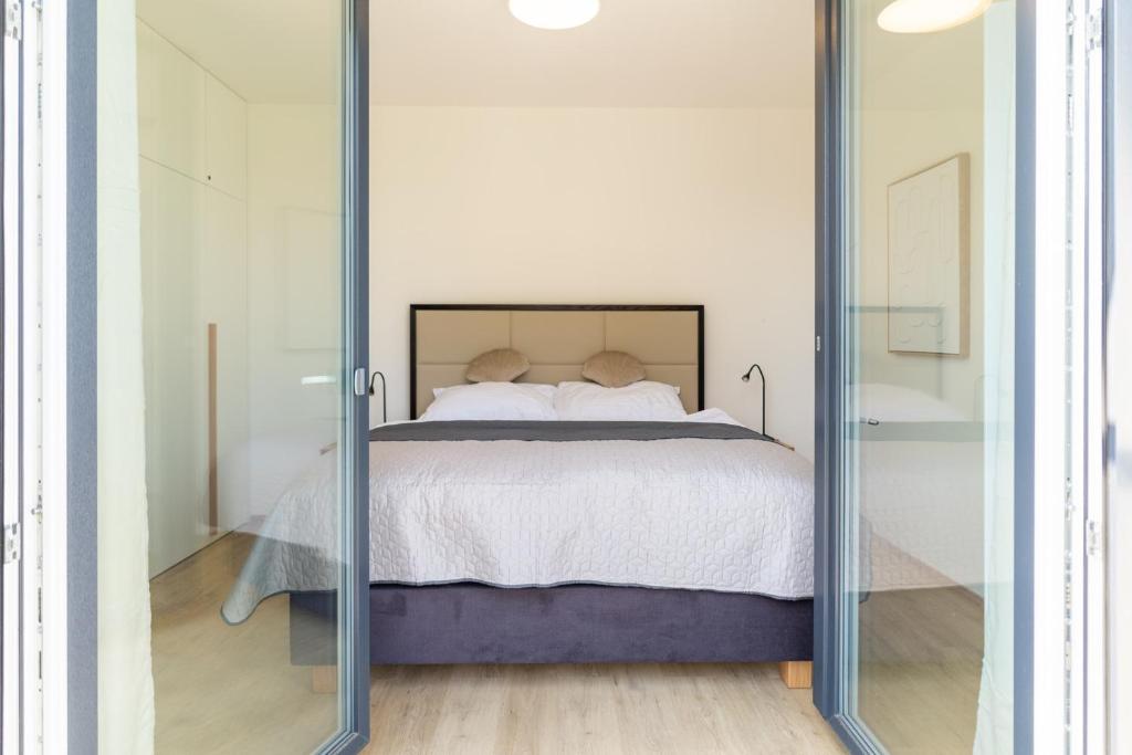 Postel nebo postele na pokoji v ubytování SOLARIS APARTMÁNY Pálava