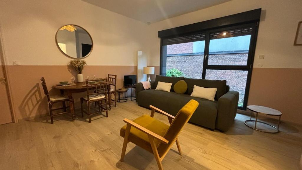 a living room with a couch and a table at Quiet and central, 6p fully equipped in Arras