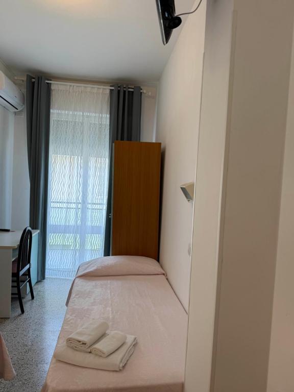 Postel nebo postele na pokoji v ubytování Hotel Gin sul mare