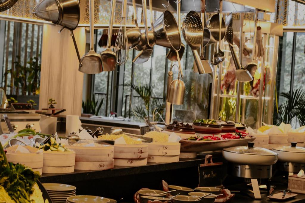 a kitchen with lots of pots and pans and utensils at The Botanica Sanctuary in Puncak