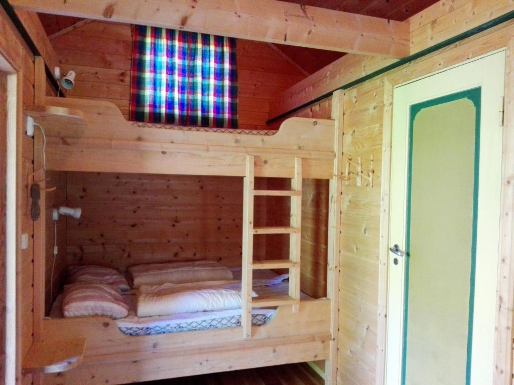 a wooden cabin with two bunk beds in it at Vårsetra in Bø