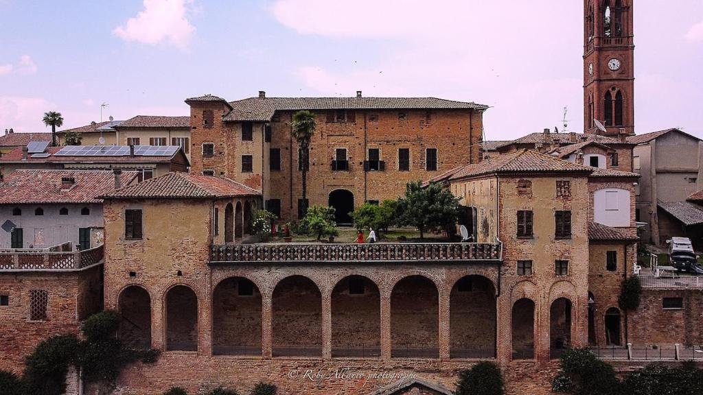 an old building with a clock tower and a bridge at Dimora PANE in Fubine