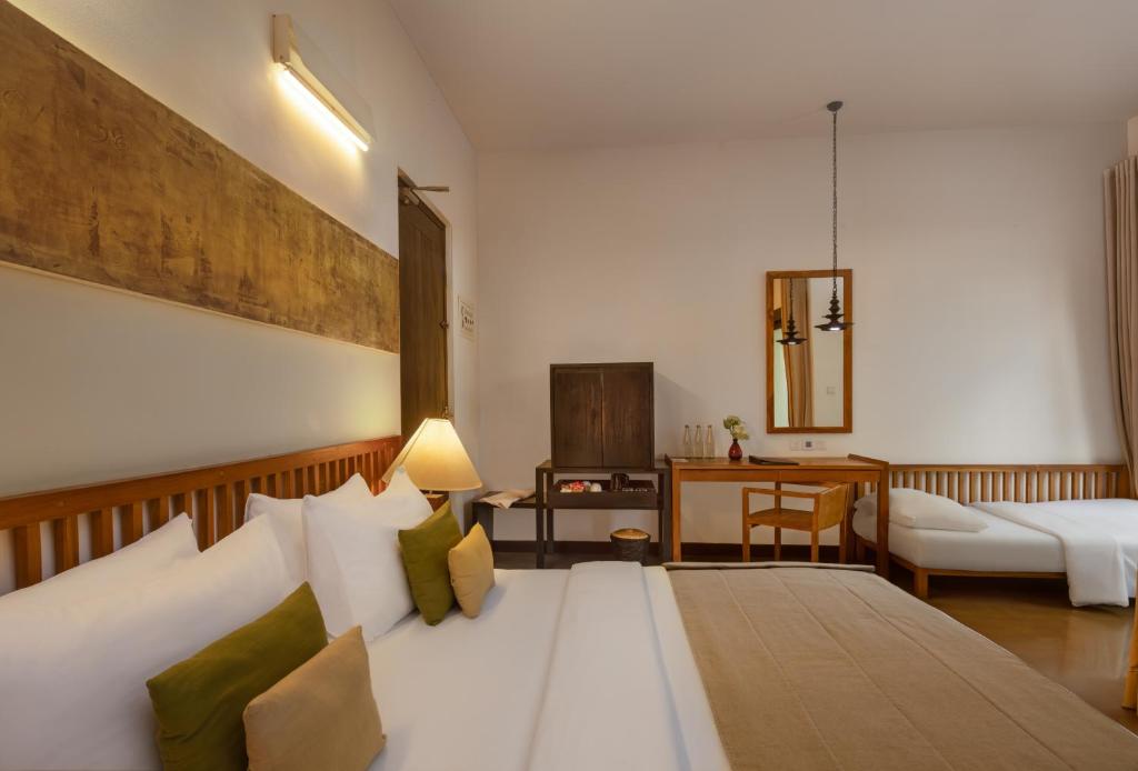 Postel nebo postele na pokoji v ubytování SigiriyaJungles Resort & Spa