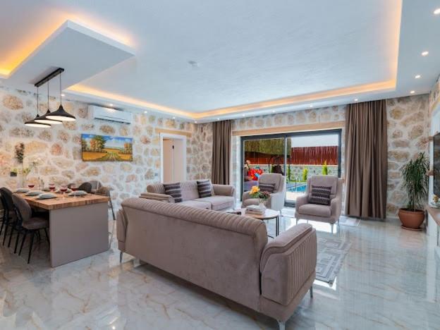 a large living room with a couch and a table at Villa Elsia, the favorite of 2025 in Çavdır