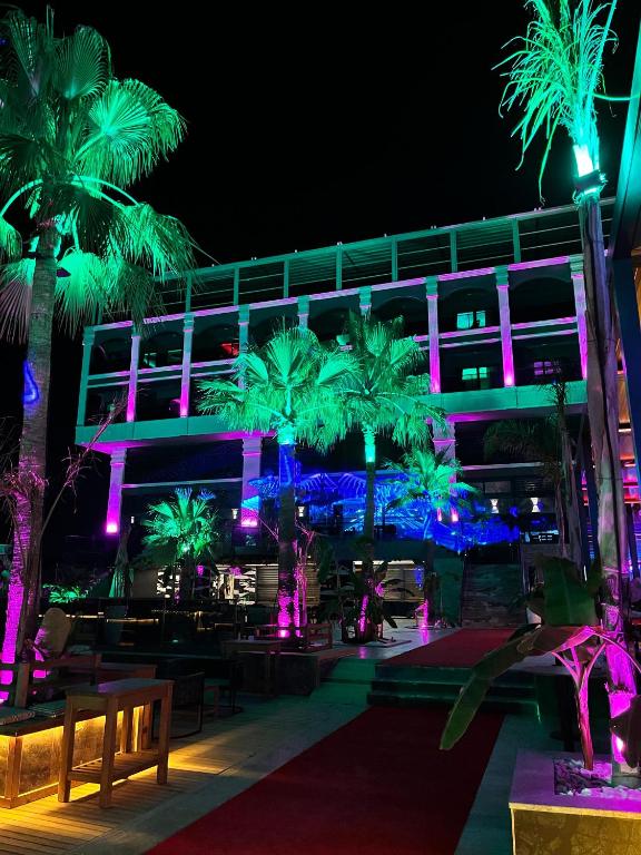 a building with palm trees and purple lights at Club Robin Hood Hotel Adults Only in Alanya
