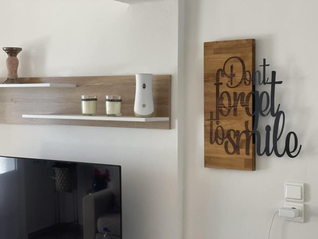 a living room with a tv and a white wall at Mylo Casa Karfas in Chios