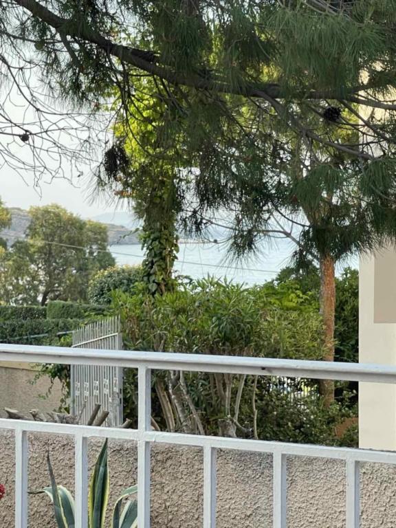 a white fence with a view of the ocean at Mylo Casa Karfas in Chios