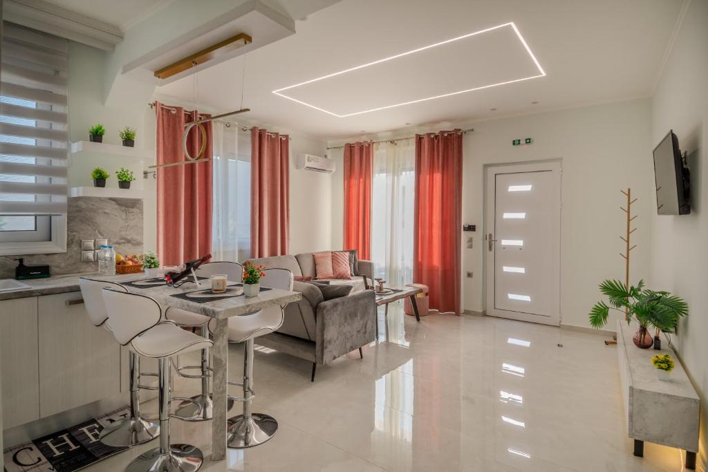 a kitchen and living room with a table and chairs at Zoi Elegant Apartments Filiatra in Filiatra