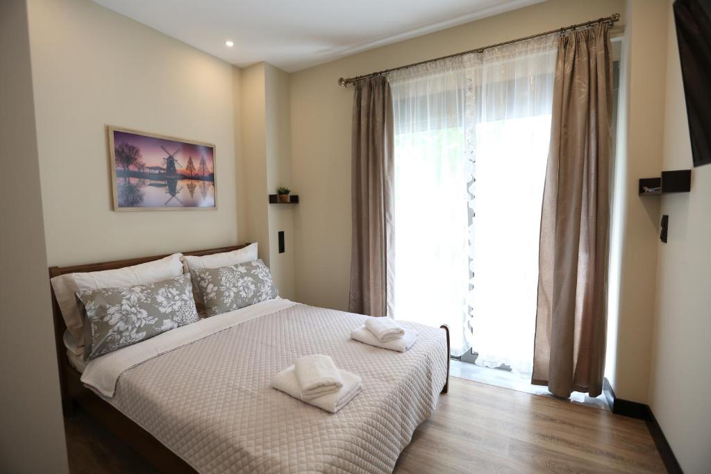 Ένα ή περισσότερα κρεβάτια σε δωμάτιο στο Loutraki Home