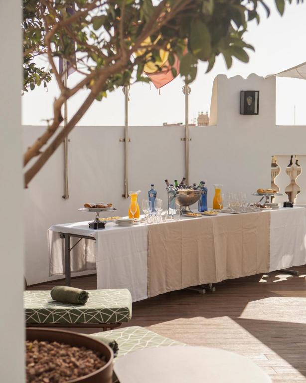 a table with white tablecloths and glasses on it at Melia Plaza Valencia in Valencia