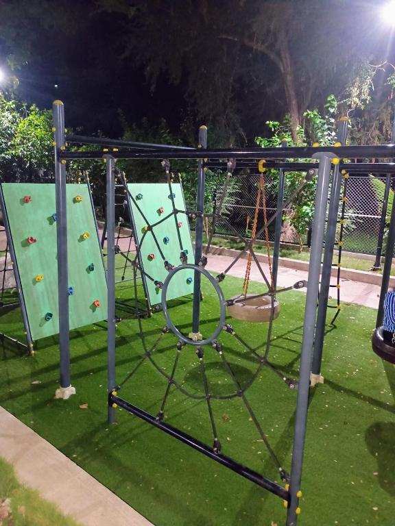 an empty playground with two slides and a swing at Aapka home in Neral