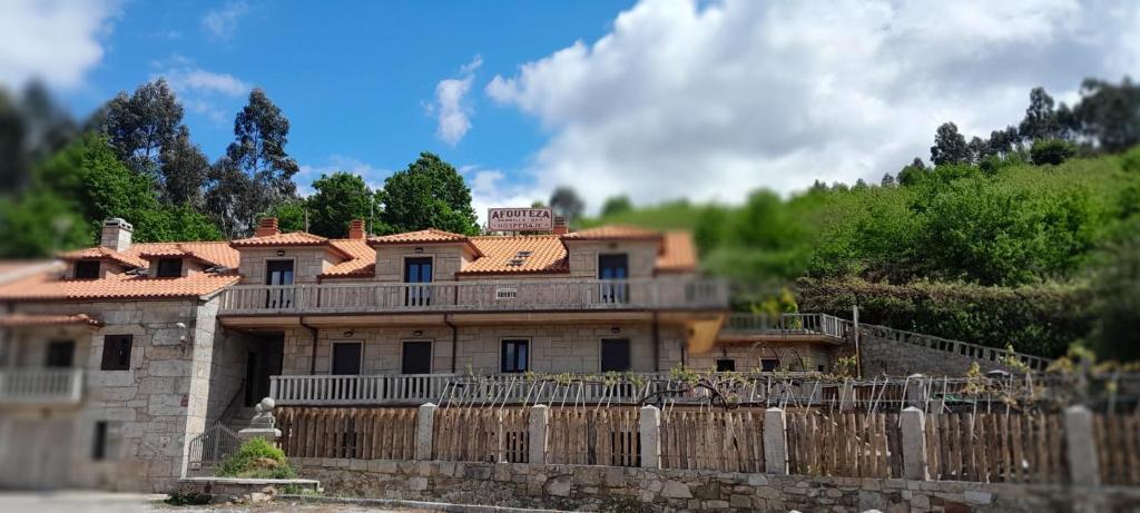 a large house behind a wooden fence at Afouteza in Pontevedra