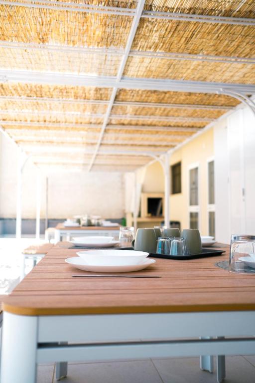 a wooden table with a plate on top of it at Dal Monaco - casa verde in Castellana Grotte