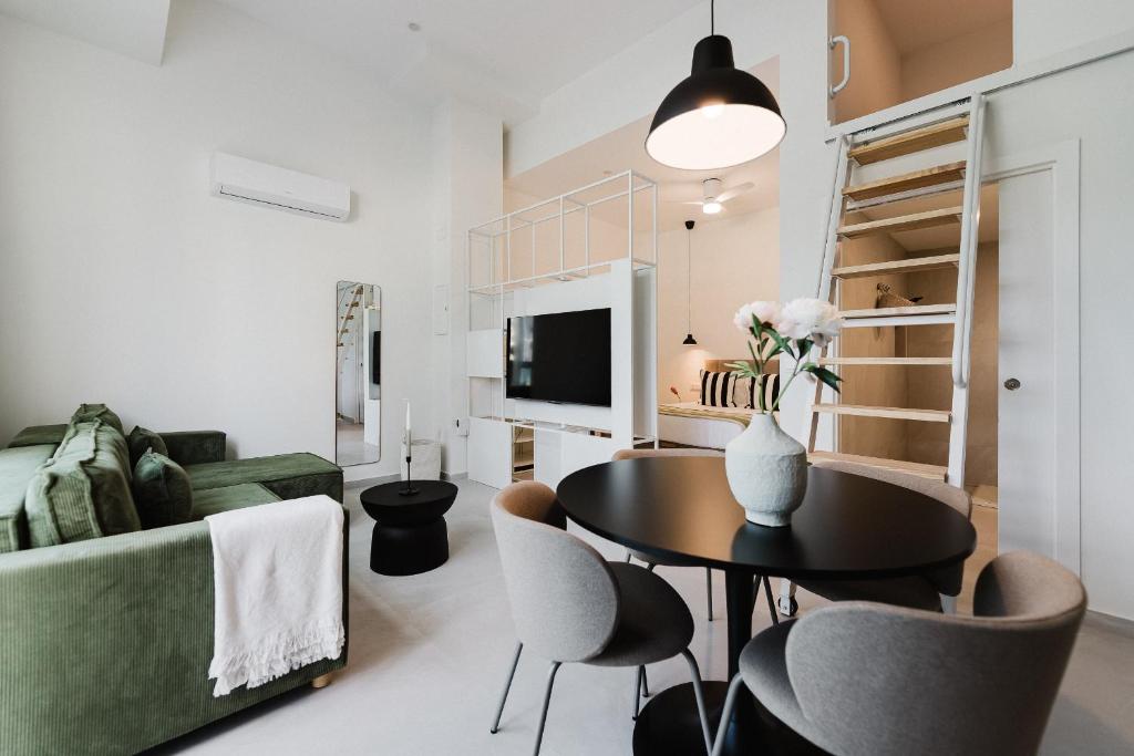 a living room with a table and chairs and a couch at Gran Turia Apartments in Valencia
