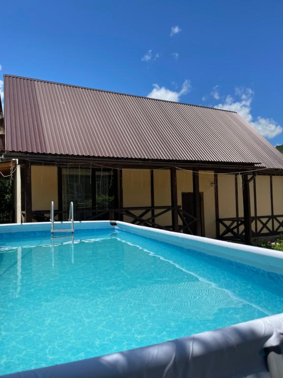 a large swimming pool in front of a building at Jelini Villa in Dilijan