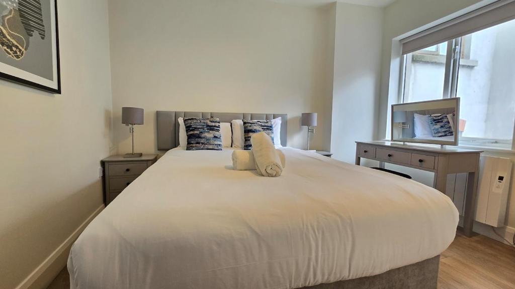 a bedroom with a large white bed and a desk at Galway City Centre, 3 bedroom, sleeps 6 in Galway