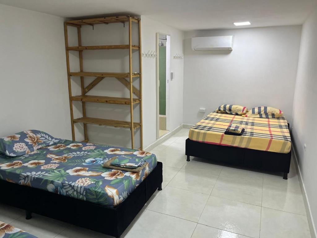 a room with two beds in a room at Habitación cerca a la playa 104 in Cartagena de Indias
