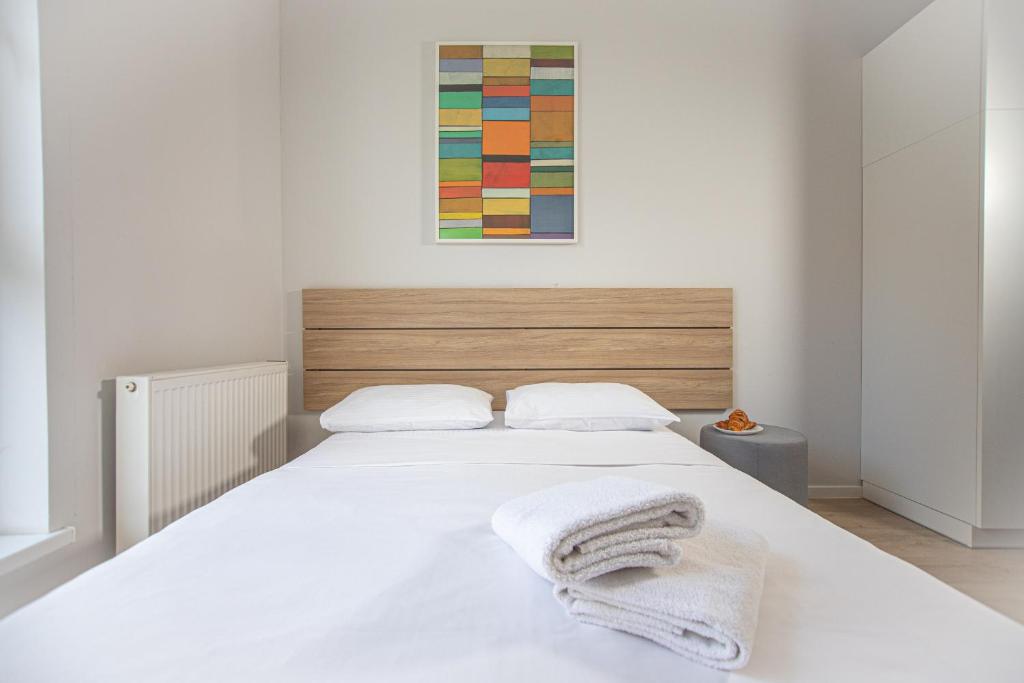 Posteľ alebo postele v izbe v ubytovaní Apartamenty Collegia