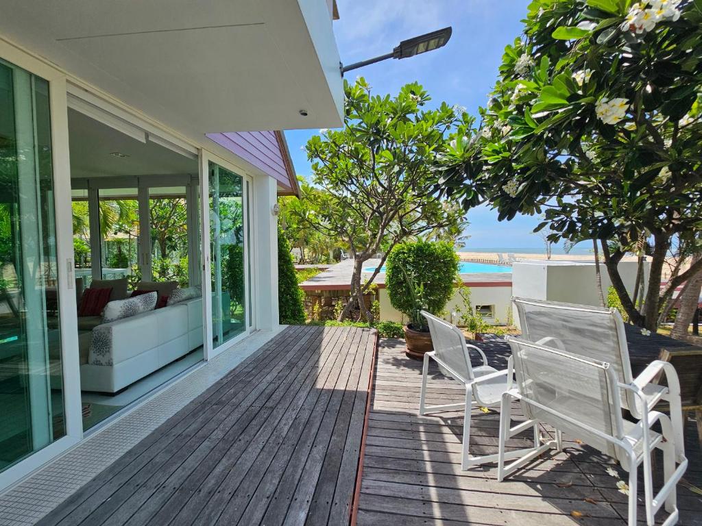 a deck with two chairs and a couch on a house at LELAWADEE Villa Cha -Am 