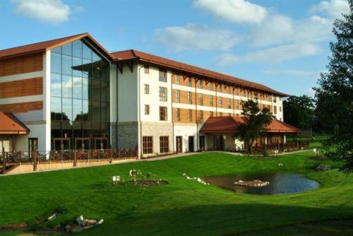 a large building with a pond in front of it at Chessington Hotel in Chessington