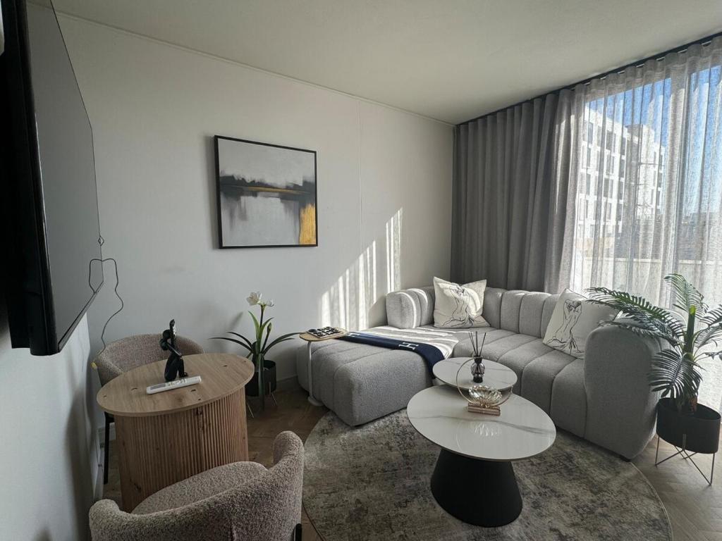 a living room with a couch and a table at Dante One Rosebank Apartment in Johannesburg