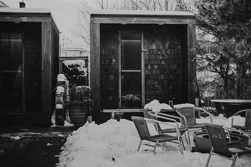 a house covered in snow with chairs and a fire hydrant at The August House in Windsor