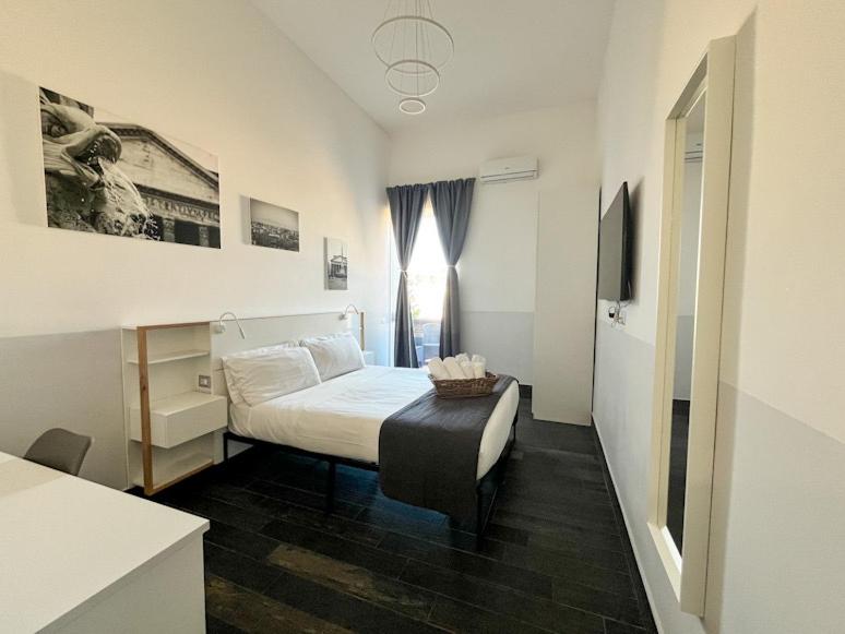 Ένα ή περισσότερα κρεβάτια σε δωμάτιο στο Arch Rome Suites
