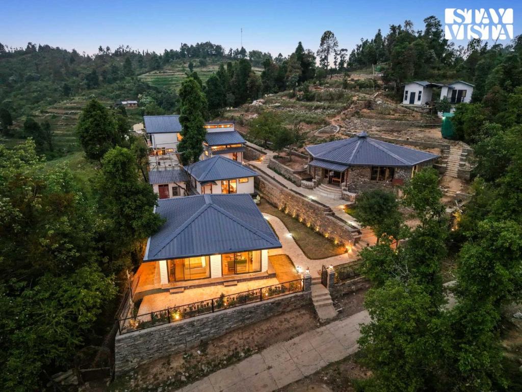 an aerial view of a house with a roof at StayVista at Cujo's Haus with Heated Floor, Bonfire, WiFi, BBQ in Mukteshwar